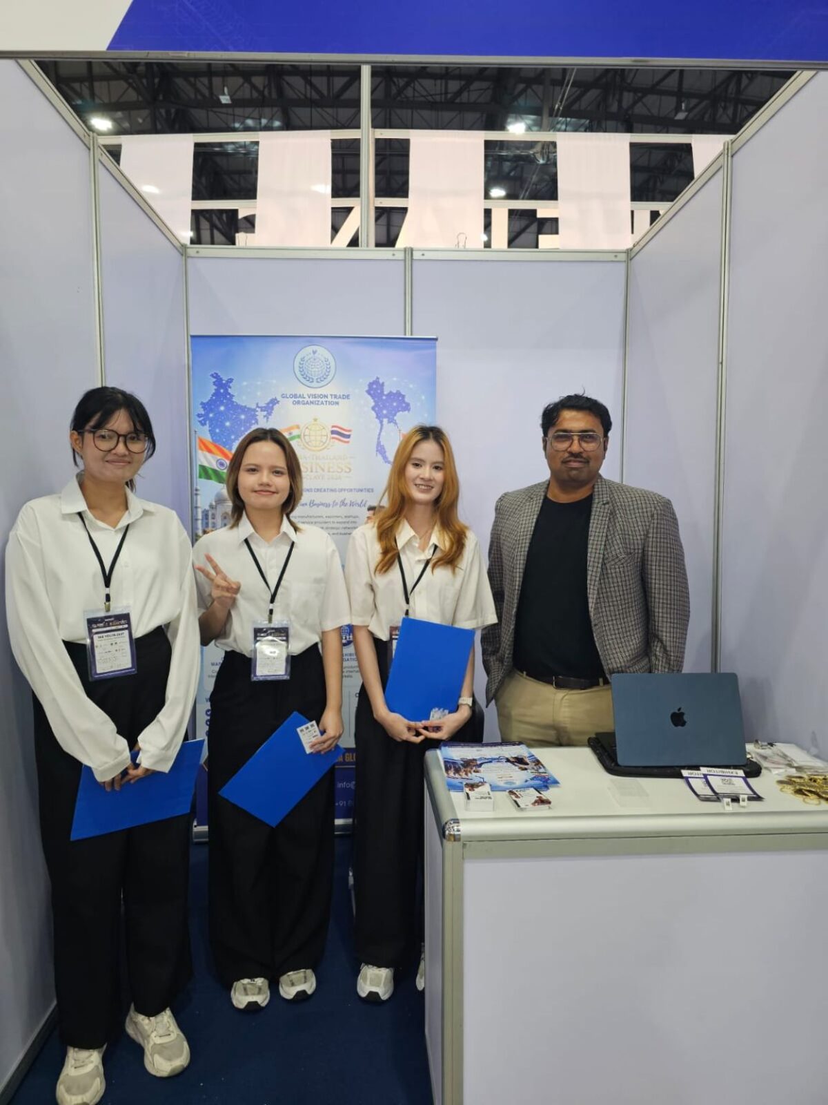 Meet the GVTO Team — The GVTO team at the booth with brochures and a laptop, ready to introduce global trade and investment initiatives to visiting professionals.