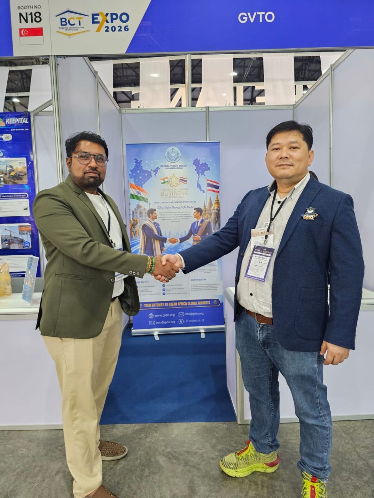 Building Business Relationships — A handshake beside the GVTO conclave standee reflects the professional networking and relationship-building at the heart of GVTO's presence at the expo.