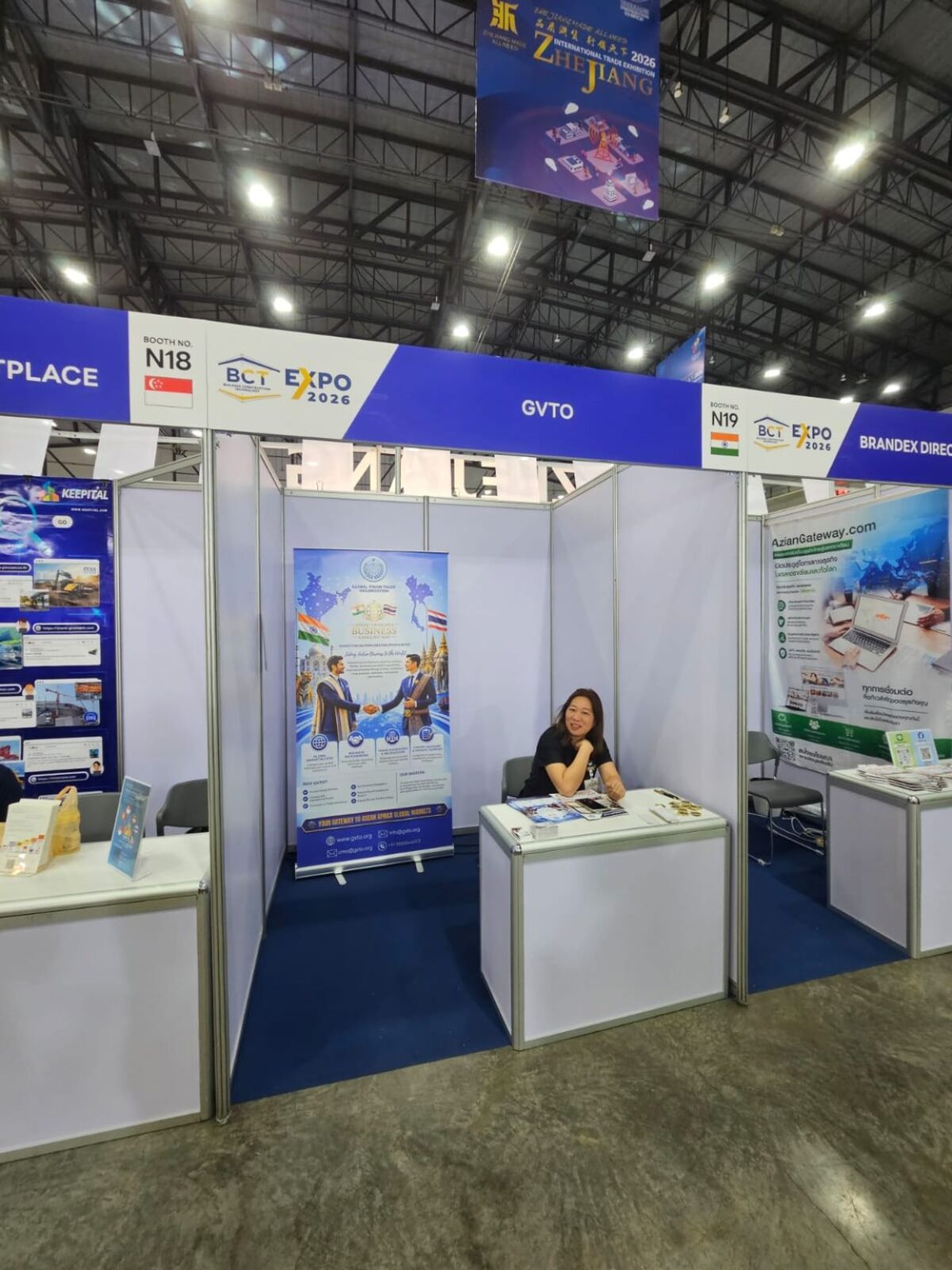 GVTO at Booth N19 — A wide view of GVTO's stand at Booth N19, where a team member welcomes visitors to learn about India–Thailand business opportunities.