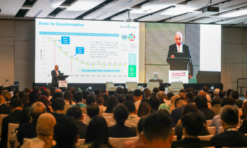 Speaker presenting on decarbonisation to a full conference hall at an ICW & BuildXpo Malaysia session